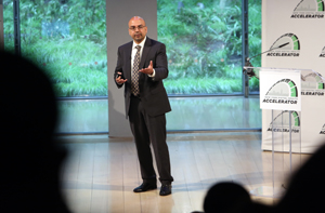 White man speaking in front of a crowd and gesturing.